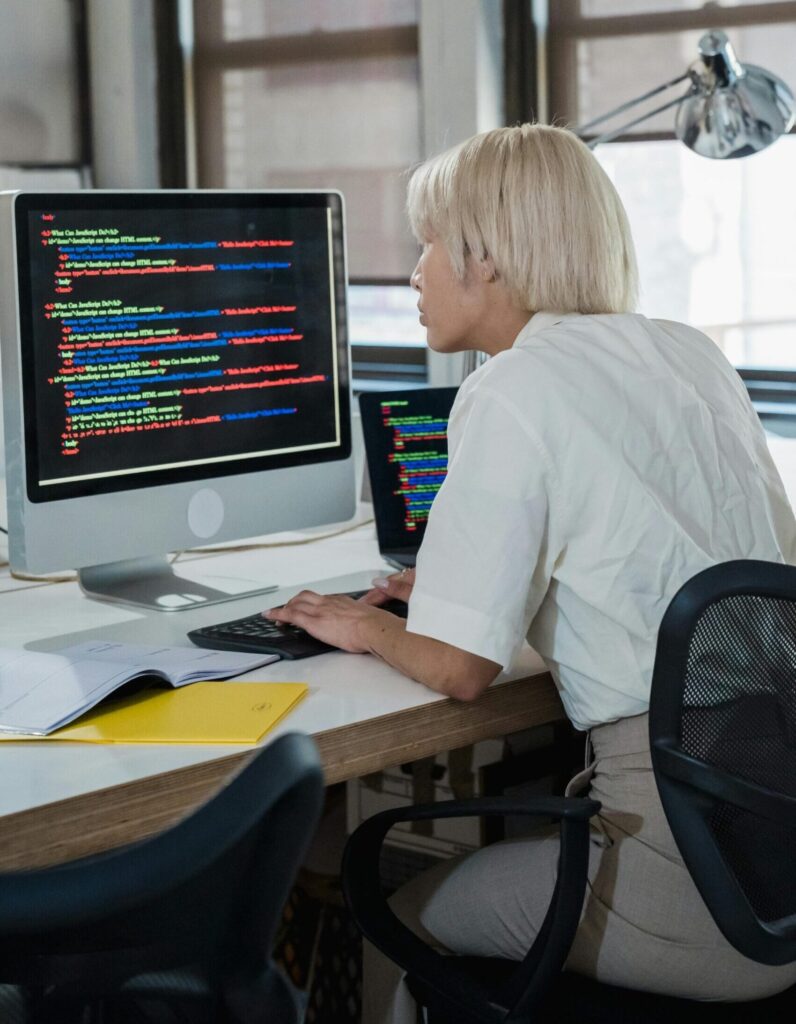 Developer working on code, representing software development and web solutions